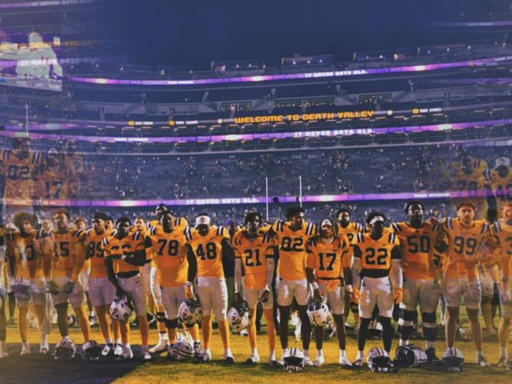 Team gathered on the field under the lights