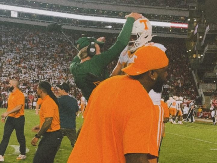 Players celebrating in orange on the sideline