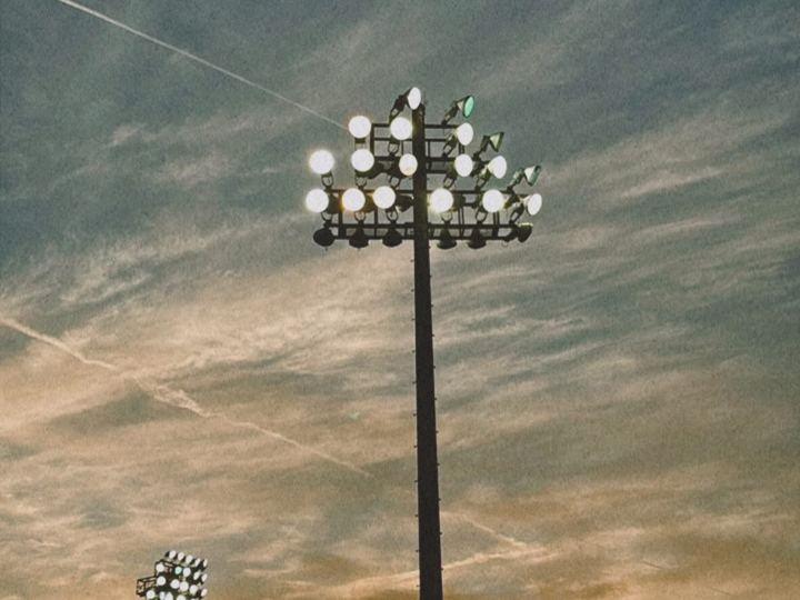Stadium light tower against a hazy sky
