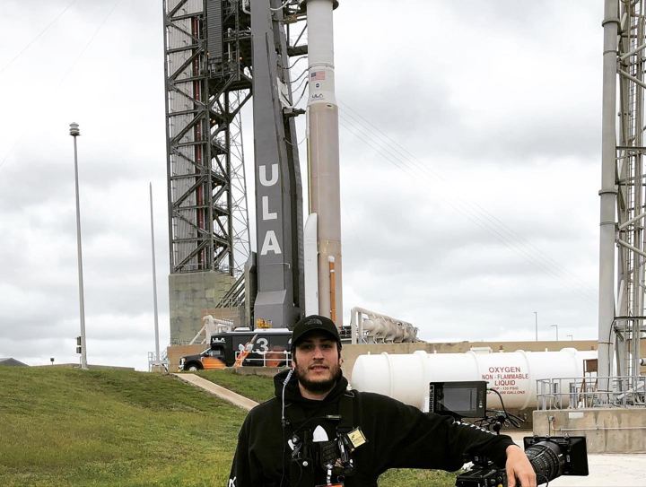 Crew member at the launch site with the tower behind