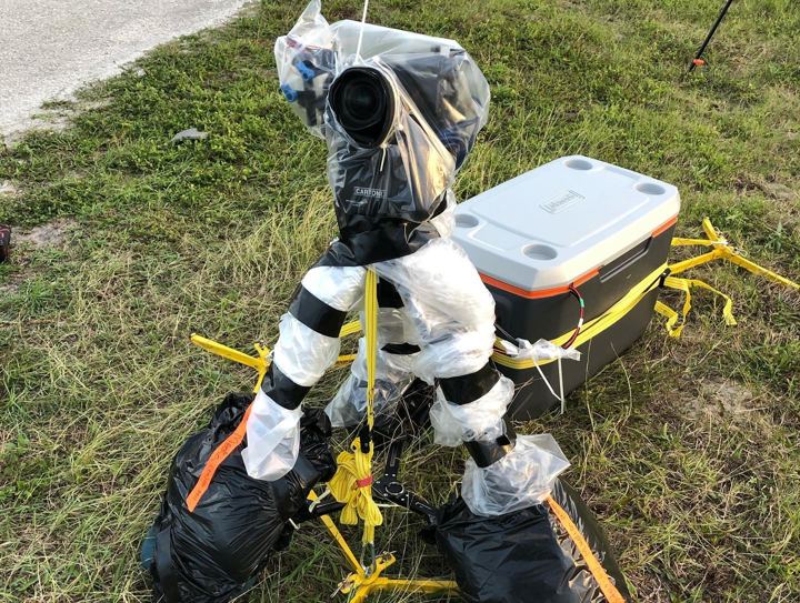 Remote camera kit staked into the grass near the pad