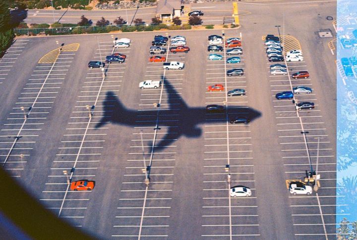 Plane shadow over a parking lot from the air