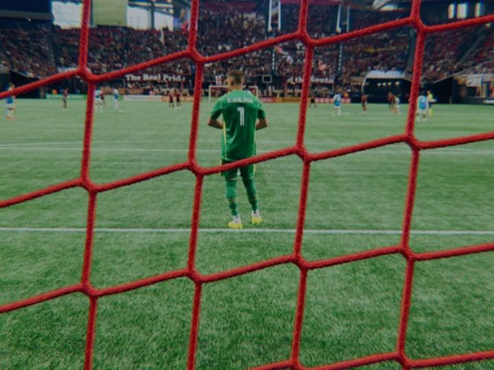 Goalkeeper seen through the net