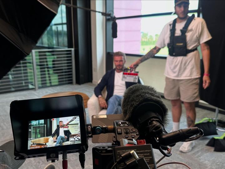 Interview monitor on set with crew behind