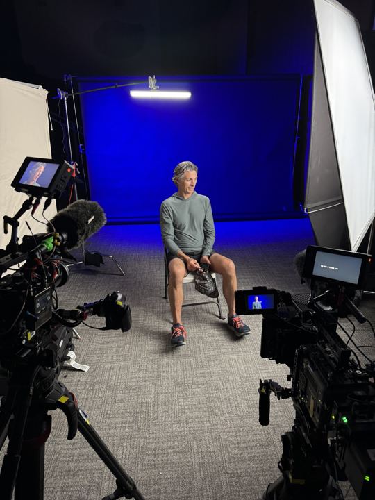 Two-camera interview set with a blue backdrop