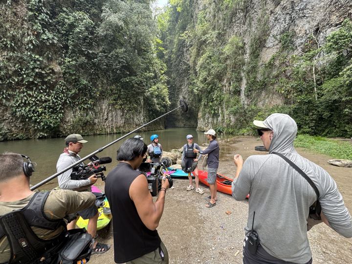 Crew prepping a river shoot in a jungle gorge
