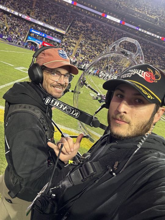 On the field with the camera team at a night game